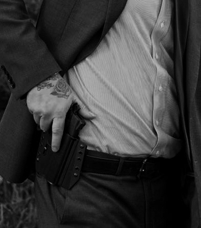 Executive protection agent drawing pistol